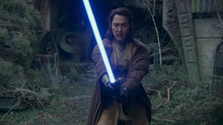 Sol, a Jedi with long hair, is stood in a fighting position, lightsaber lit.